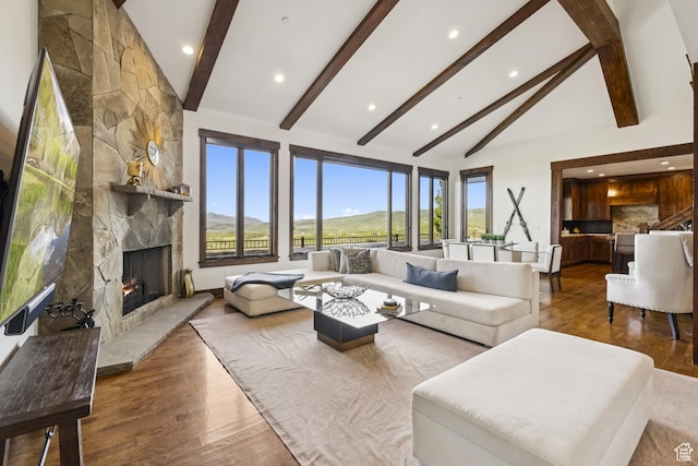 9079 Dye Cabins Dr, Park City, UT 84098 - living area featuring a stone fireplace, wood finished floors, beamed ceiling, recessed lighting, and high vaulted ceiling