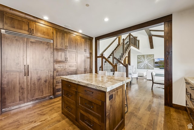 9079 Dye Cabins Dr, Park City, UT 84098 - kitchen featuring paneled fridge, wood finished floors, a breakfast bar area, a kitchen island, and recessed lighting