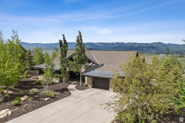 9079 Dye Cabins Dr, Park City, UT 84098 - view of front of property featuring a standing seam roof, a metal roof, concrete driveway, a garage, and a mountain view