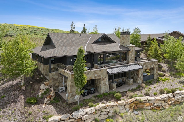 9079 Dye Cabins Dr, Park City, UT 84098 - back of property with a patio area, stone siding, and a chimney
