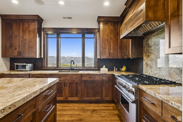9079 Dye Cabins Dr, Park City, UT 84098 - kitchen with high end stainless steel range, custom exhaust hood, dark wood-type flooring, recessed lighting, and backsplash