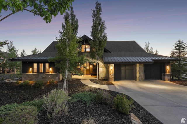 9079 Dye Cabins Dr, Park City, UT 84098 - view of front of house featuring a standing seam roof, stone siding, a metal roof, driveway, and a garage