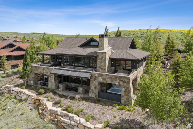 9079 Dye Cabins Dr, Park City, UT 84098 - rear view of house with stone siding, a patio area, a chimney, a balcony, and a shingled roof
