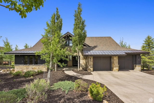 9079 Dye Cabins Dr, Park City, UT 84098 - view of front facade featuring a standing seam roof, a metal roof, stone siding, concrete driveway, and a garage