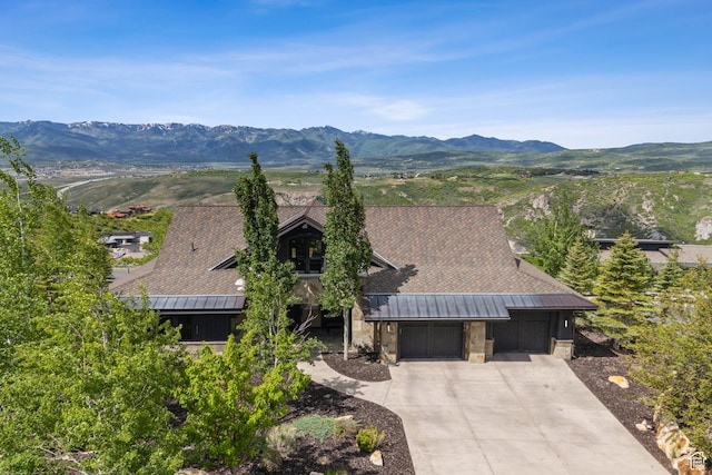 9079 Dye Cabins Dr, Park City, UT 84098 - view of front of home featuring an attached garage, stone siding, driveway, and a mountain view