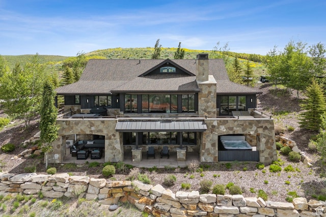 9079 Dye Cabins Dr, Park City, UT 84098 - back of house with stone siding, a chimney, a patio, an outdoor hangout area, and roof with shingles