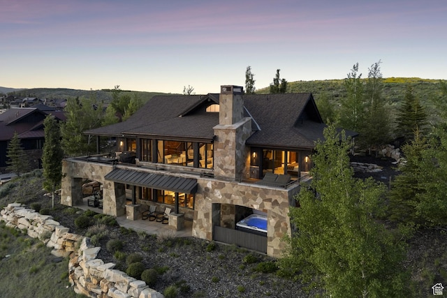 9079 Dye Cabins Dr, Park City, UT 84098 - back of house with stone siding, a patio area, a chimney, and a balcony