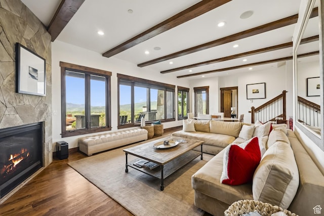 9079 Dye Cabins Dr, Park City, UT 84098 - living area with a fireplace, wood finished floors, recessed lighting, beam ceiling, and stairs