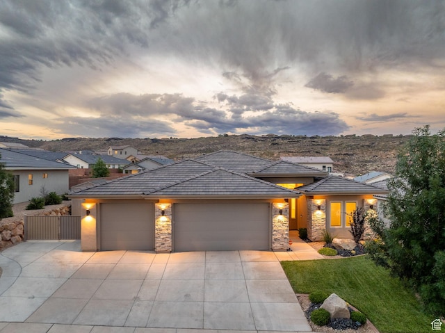 886 N Sandy Talus Dr, Washington, UT 84780 - prairie-style home with a garage, stone siding, driveway, a yard, and stucco siding