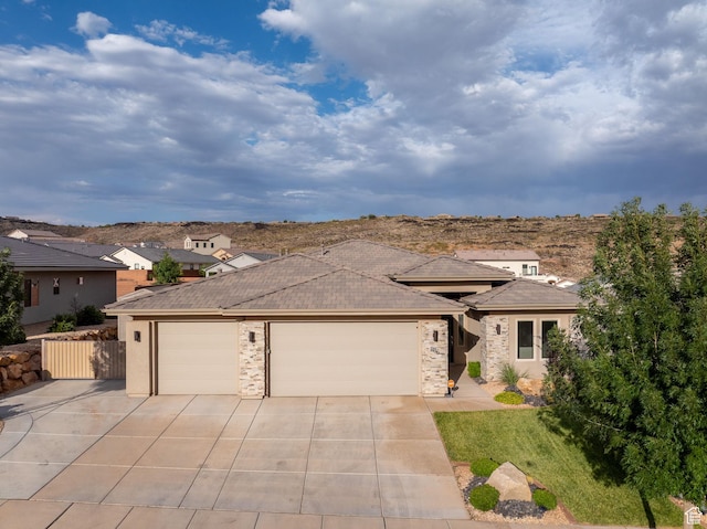 886 N Sandy Talus Dr, Washington, UT 84780 - view of front facade with driveway, an attached garage, and stone siding