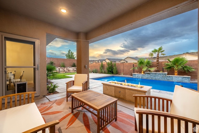 886 N Sandy Talus Dr, Washington, UT 84780 - pool at dusk with an outdoor fire pit, a fenced backyard, and a patio