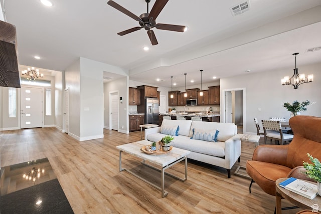 886 N Sandy Talus Dr, Washington, UT 84780 - living room with a chandelier, ceiling fan, light wood-type flooring, and recessed lighting