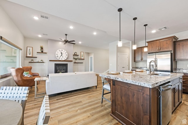 886 N Sandy Talus Dr, Washington, UT 84780 - kitchen with stainless steel appliances, light wood-type flooring, a ceiling fan, light stone countertops, and open floor plan