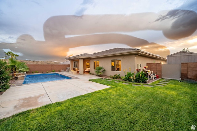886 N Sandy Talus Dr, Washington, UT 84780 - pool at dusk featuring a fenced backyard and a patio area