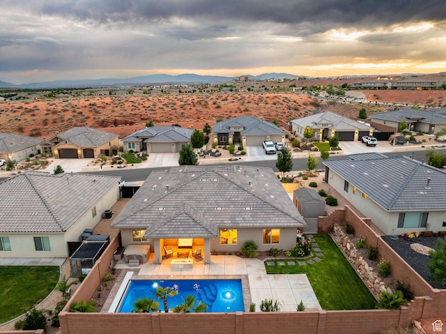 886 N Sandy Talus Dr, Washington, UT 84780 - pool at dusk with a fenced backyard, a residential view, and a mountain view