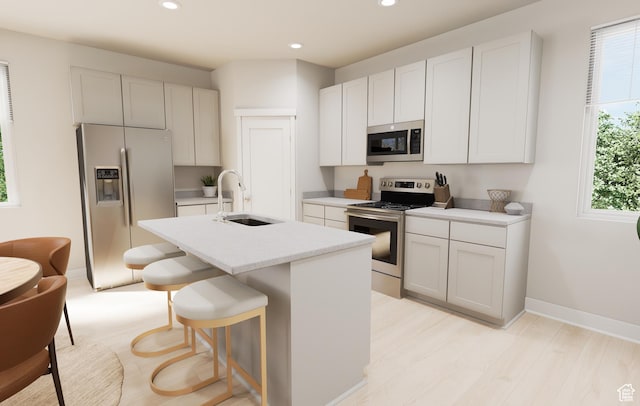 1343 N 1390 E Unit 27-104, Payson, UT 84651 - kitchen with stainless steel appliances, recessed lighting, an island with sink, a kitchen breakfast bar, and light countertops