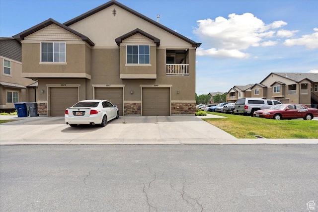 1049 W Allington Dr N, North Salt Lake, UT 84054 - view of property with stone siding, a garage, stucco siding, driveway, and a residential view