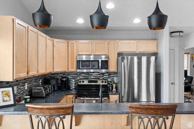 1049 W Allington Dr N, North Salt Lake, UT 84054 - kitchen with appliances with stainless steel finishes, light brown cabinets, dark countertops, and recessed lighting