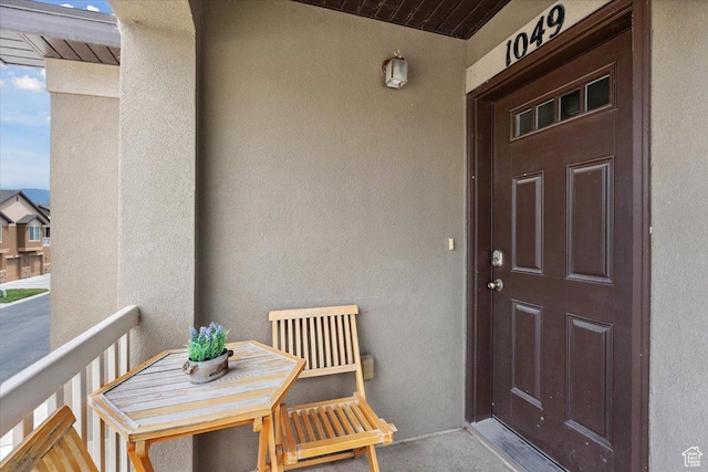1049 W Allington Dr N, North Salt Lake, UT 84054 - doorway to property featuring stucco siding and a balcony