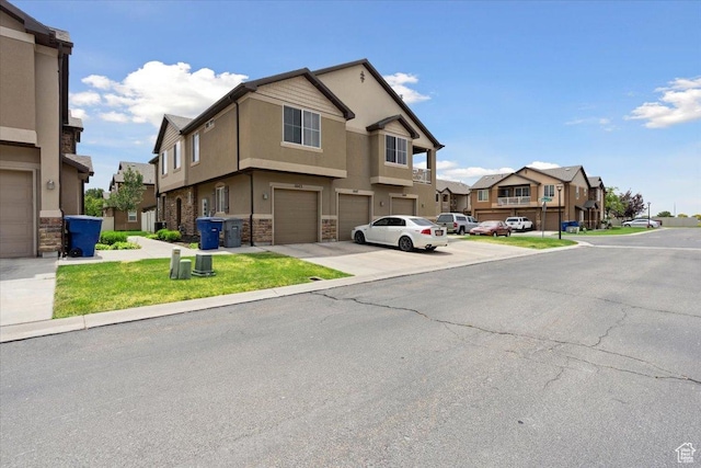 1049 W Allington Dr N, North Salt Lake, UT 84054 - view of front of house featuring a residential view, stone siding, a garage, stucco siding, and driveway