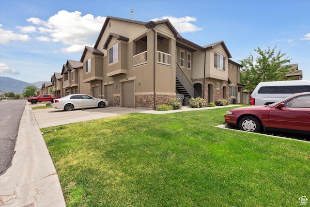 1049 W Allington Dr N, North Salt Lake, UT 84054 - view of property featuring an attached garage, stairway, and a mountain view