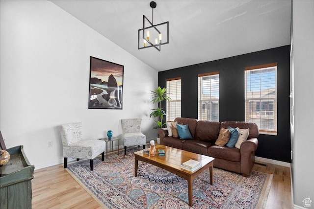 1049 W Allington Dr N, North Salt Lake, UT 84054 - living room featuring lofted ceiling, a chandelier, and light wood finished floors