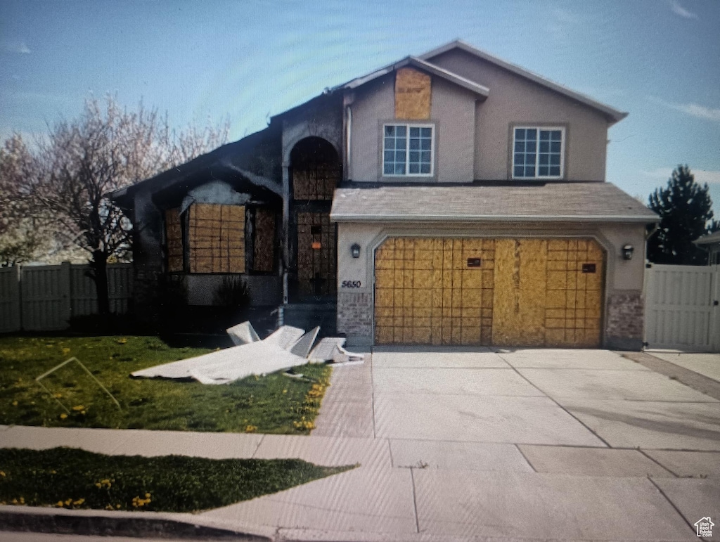 5650 W Mountain Aura Dr, West Jordan, UT 84084 - view of front facade featuring a garage, concrete driveway, and stucco siding