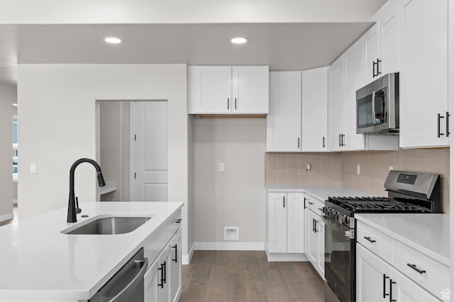 1918 S 2475 W, West Haven, UT 84401 - kitchen featuring appliances with stainless steel finishes, light wood-style floors, recessed lighting, light countertops, and backsplash