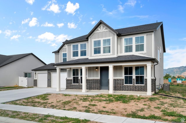 1918 S 2475 W, West Haven, UT 84401 - view of front of home featuring board and batten siding, covered porch, driveway, an attached garage, and brick siding