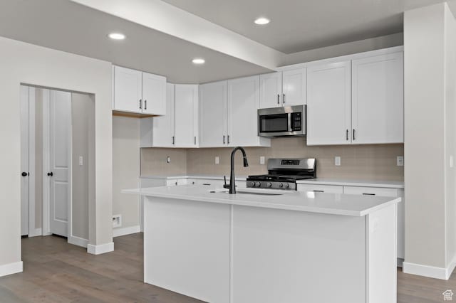 1918 S 2475 W, West Haven, UT 84401 - kitchen featuring appliances with stainless steel finishes, light countertops, tasteful backsplash, light wood finished floors, and recessed lighting