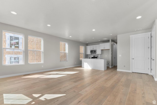 3932 W 2800 N, Lehi, UT 84043 - unfurnished living room with recessed lighting and light wood finished floors