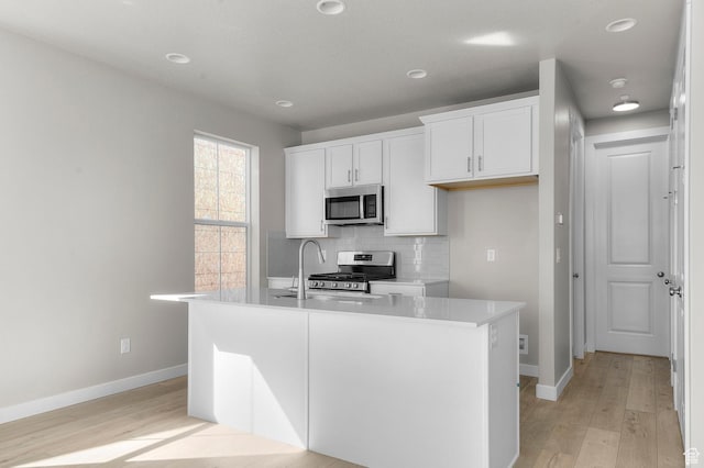 3932 W 2800 N, Lehi, UT 84043 - kitchen with stainless steel appliances, light wood-style flooring, white cabinetry, decorative backsplash, and recessed lighting