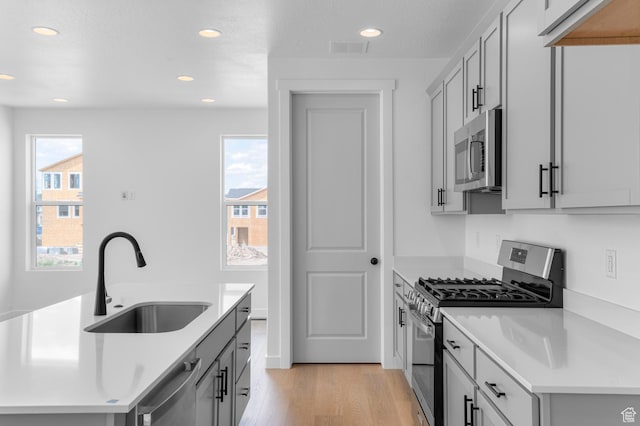 3908 W 2720 N, Lehi, UT 84043 - kitchen featuring stainless steel appliances, light wood finished floors, healthy amount of natural light, recessed lighting, and light countertops