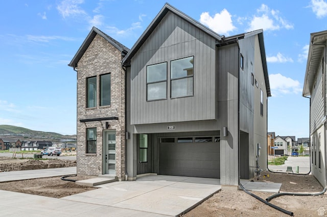 3908 W 2720 N, Lehi, UT 84043 - modern home featuring an attached garage, driveway, and brick siding