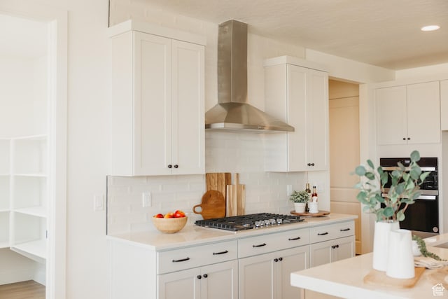 3757 E 1120, Spanish Fork, UT 84660 - kitchen with wall chimney range hood, light countertops, white cabinets, stainless steel appliances, and recessed lighting