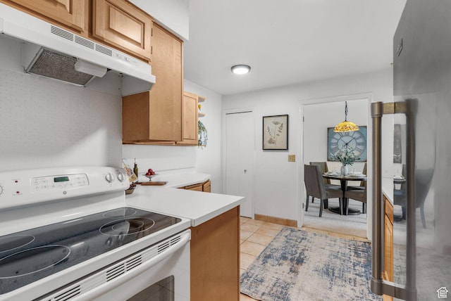 875 S Donner Way E Unit 302, Salt Lake City, UT 84108 - kitchen with white range with electric cooktop, under cabinet range hood, light countertops, and light tile patterned floors