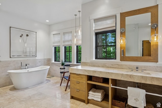2505 W White Pine Ln, Park City, UT 84060 - bathroom with tile walls, a soaking tub, vanity, a wainscoted wall, and marble finish flooring