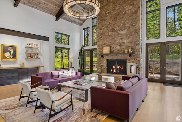 2505 W White Pine Ln, Park City, UT 84060 - living room featuring wood finished floors, high vaulted ceiling, french doors, a wood ceiling with exposed beams, and a stone fireplace