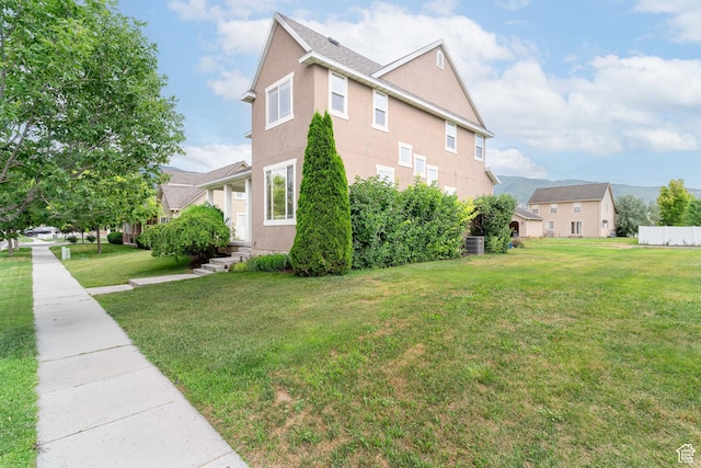 17 S Belmont Dr, Farmington, UT 84025 - view of home's exterior featuring a lawn and stucco siding