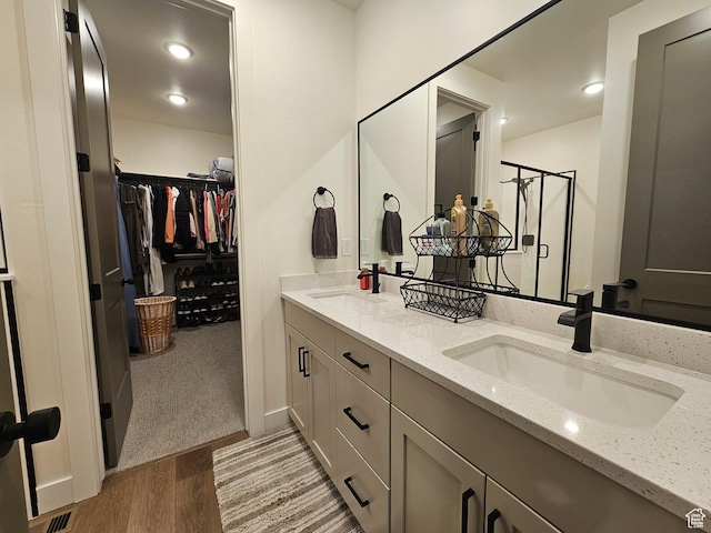 964 E 50 S, Santaquin, UT 84655 - full bath featuring wood finished floors, double vanity, a stall shower, a walk in closet, and recessed lighting