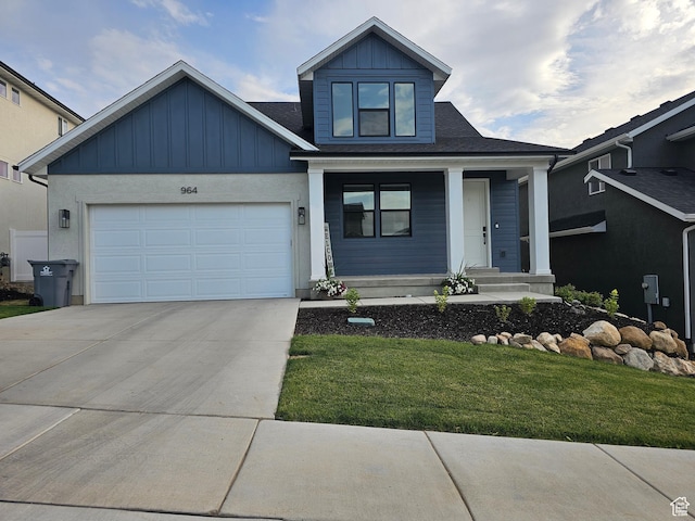 964 E 50 S, Santaquin, UT 84655 - view of front of house featuring concrete driveway, board and batten siding, a porch, a garage, and a front lawn