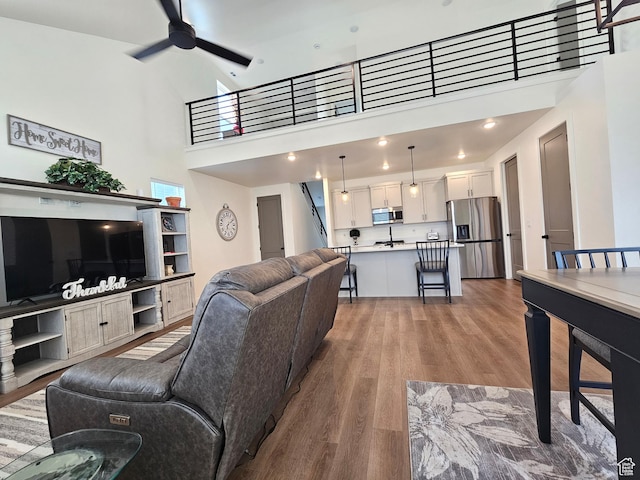964 E 50 S, Santaquin, UT 84655 - living area featuring a ceiling fan, wood finished floors, a towering ceiling, and stairway