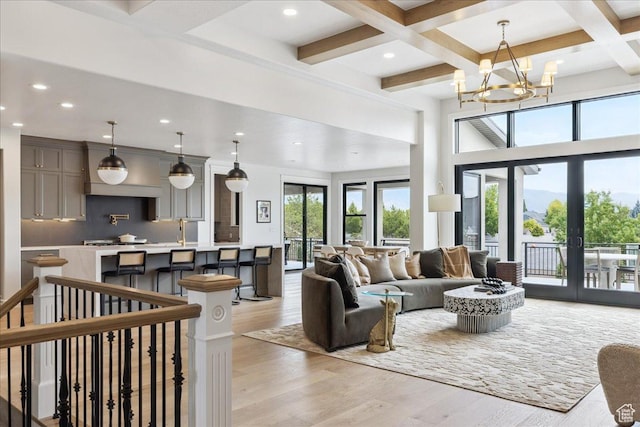 1649 W Pheasant Meadow Dr, Kaysville, UT 84037 - living room featuring french doors, light wood finished floors, beamed ceiling, recessed lighting, and a chandelier