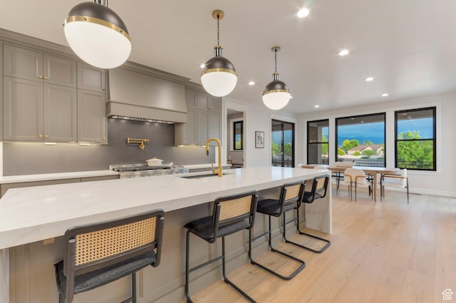 1649 W Pheasant Meadow Dr, Kaysville, UT 84037 - kitchen featuring premium range hood, recessed lighting, light wood finished floors, plenty of natural light, and gray cabinets