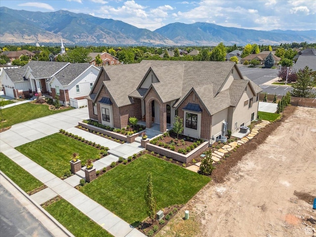 1649 W Pheasant Meadow Dr, Kaysville, UT 84037 - tudor home featuring driveway, a residential view, a mountain view, and a front lawn