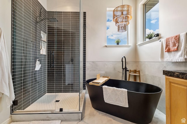 2151 E Village Vista Dr, Draper, UT 84020 - bathroom with tile walls, a shower stall, and a soaking tub