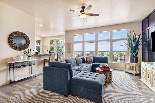 2151 E Village Vista Dr, Draper, UT 84020 - living area with healthy amount of natural light, wood finished floors, ceiling fan, and recessed lighting