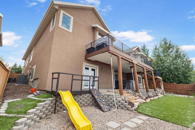 2151 E Village Vista Dr, Draper, UT 84020 - rear view of property with a fenced backyard, stucco siding, a deck, and a playground