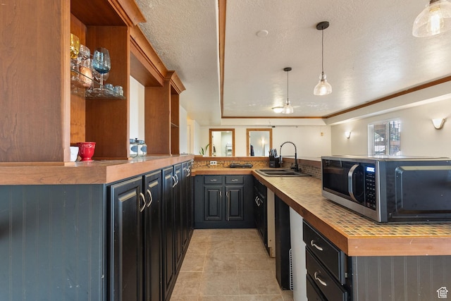 2151 E Village Vista Dr, Draper, UT 84020 - kitchen featuring stainless steel microwave, a peninsula, butcher block countertops, light tile patterned floors, and pendant lighting