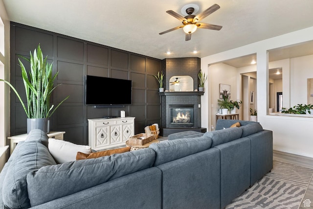 2151 E Village Vista Dr, Draper, UT 84020 - living room with ceiling fan, a glass covered fireplace, light wood finished floors, recessed lighting, and a decorative wall